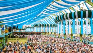 Oktoberfest Germany blue and white tent, green fixtures and crowds featured image