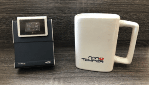 Monolith mini front view of instrument beside white NanoTemper mug