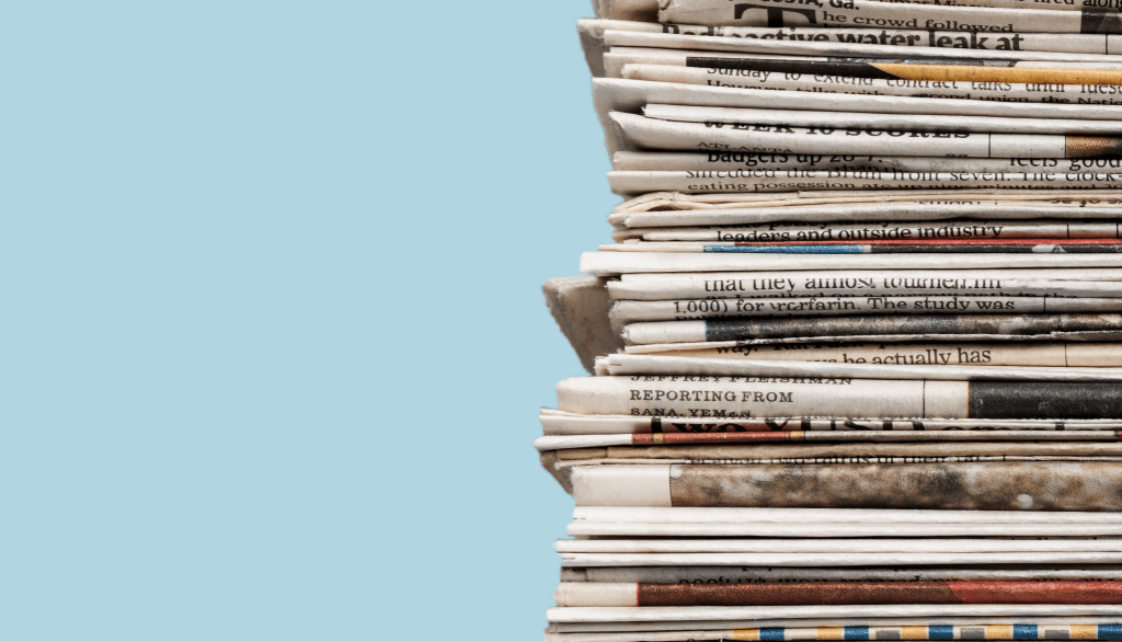 Newspaper stack and blue background featured image