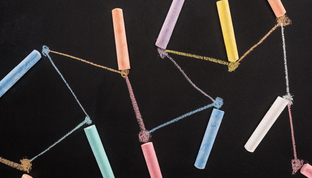 Top view of colorful chalk on black surface with connected drawn lines, connection and communication concept featured image